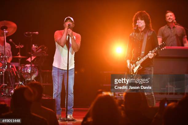 Recording Artists Darius Rucker and Tommy Thayer perform onstage during 8th Annual Darius and Friends concert at Ryman Auditorium on June 5, 2017 in...