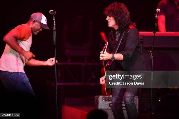 Recording Artists Darius Rucker and Tommy Thayer perform onstage during 8th Annual Darius and Friends concert at Ryman Auditorium on June 5, 2017 in...