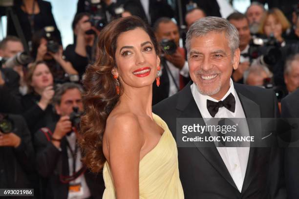 File photo dated May 12, 2016 shows US actor George Clooney and his wife Amal Clooney at the 69th Cannes Film Festival in Cannes, southern France....