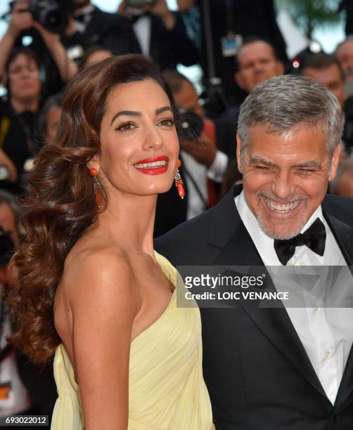 File photo dated May 12, 2016 shows US actor George Clooney and his wife Amal Clooney at the 69th Cannes Film Festival in Cannes, southern France....