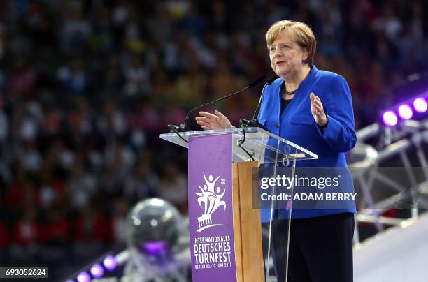 German Chancellor Angela Merkel speaks during the Stadium Gala of the 2017 Deutsches Turnfest at the Olympic Stadium in Berlin on June 6, 2017. / AFP...