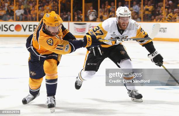 Parenteau of the Nashville Predators takes a shot past Carter Rowney of the Pittsburgh Penguins during the third period of Game Four of the 2017 NHL...