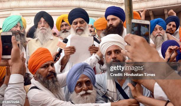 Bhai Dhian Singh Mand along with Baba Baljit Singh Daduwal addresses the gathering during a protest against Jathedar Gaini Gurbachan Singh in the...