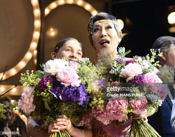 British composer, pianist, violinist Alma Deutscher and South Korean Soprano Sumi Jo stand on stage after the Life and Celebration Concert "Recognize...