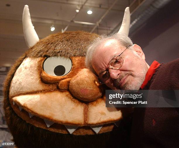 Standing with a character from his book "Where the Wild Things Are," author and illustrator Maurice Sendak speaks with the media January 11, 2002...