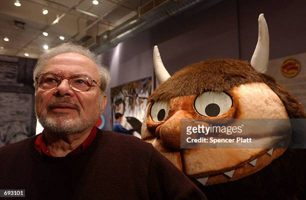 Standing with a character from his book "Where the Wild Things Are," author and illustrator Maurice Sendak speaks with the media January 11, 2002...