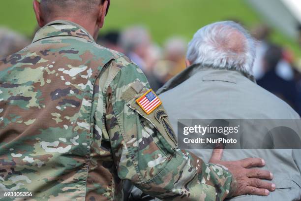 Member of the US Army helps a US D-Day Veteran ahead of the International Commemorative Ceremony of the Allied Landing in Normandy in the presence of...