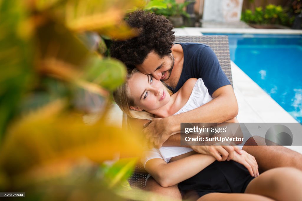 Smiling Couple Embracing Near Swimming Pool