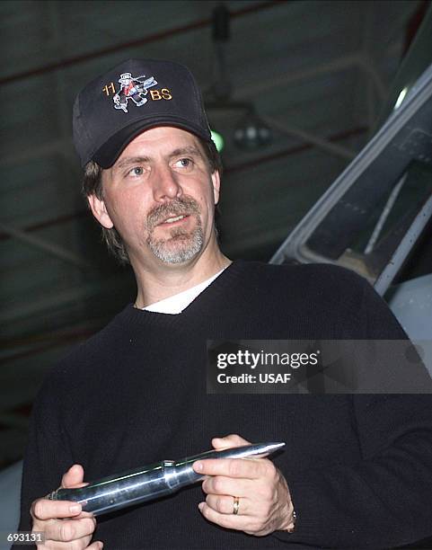 Comedian Jeff Foxworthy holds a 30mm training round from a GAU-8A gatling gun January 11, 2002 at Barksdale Air Force Base, LA. Foxworthy visited the...