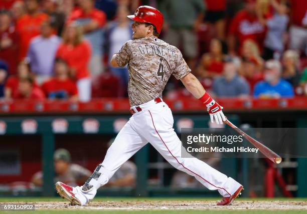 Scooter Gennett of the Cincinnati Reds watches his fourth home run against the St. Louis Cardinals at Great American Ball Park on June 6, 2017 in...