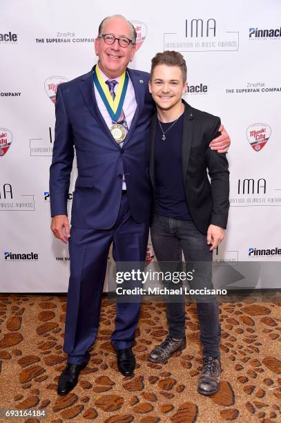 Innovator of the Year award winner John Esposito of Warner Music Nashville, and Hunter Hayes pose backstage at the Innovation In Music Awards on June...