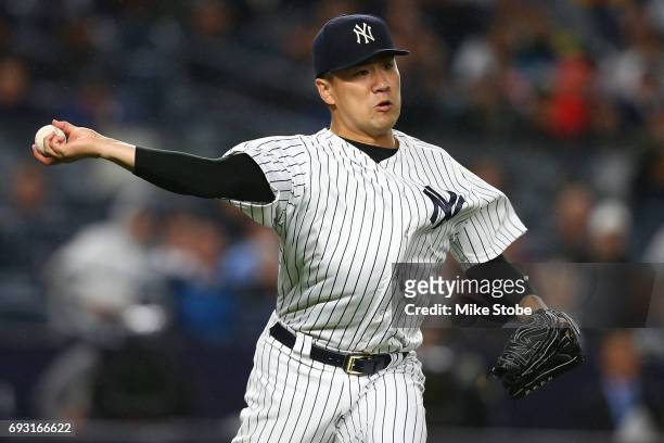 Masahiro Tanaka of the New York Yankees fields a ground out for an out in the third inning agaist the Boston Red Sox at Yankee Stadium on June 6,...