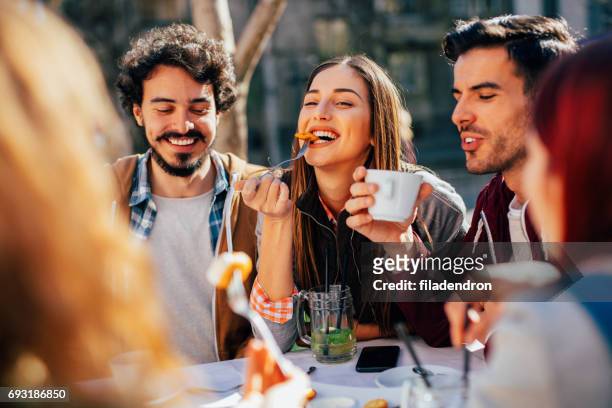 vrienden eten in een restaurant - vriendin stockfoto's en -beelden