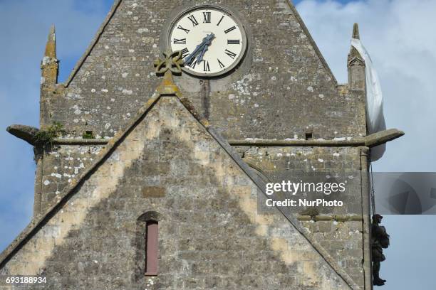 Scene memorasing a well-known incident involved paratrooper John Steele of the 505th Parachute Infantry Regiment, whose parachute caught on the spire...