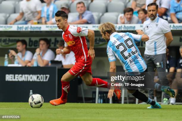 Erik Thommy of Jahn Regensburg and Stefan Aigner of 1860 Munich battle for the ball during the Second Bundesliga Playoff second leg match between TSV...