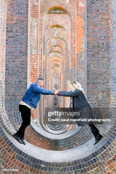 couple underneath balcombe viaduct - balcombe stock pictures, royalty-free photos & images