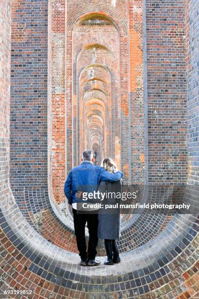 couple underneath balcombe viaduct - balcombe stock pictures, royalty-free photos & images