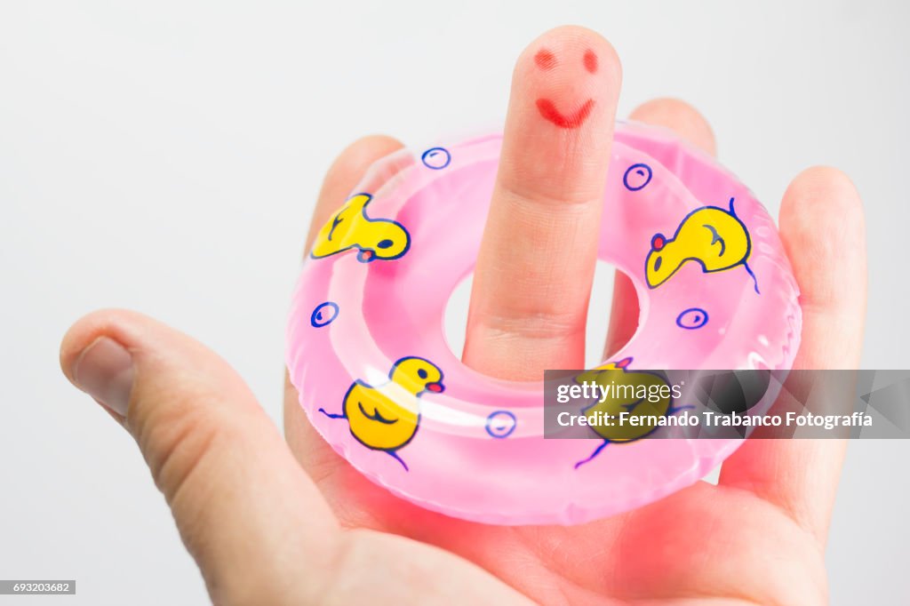 Inflatable ring with the finger of a happy lifeguard