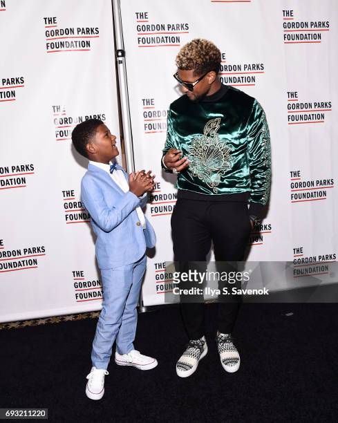 Singer-songwriter Usher Raymond IV and his son Naviyd Ely Raymond attend the 2017 Gordon Parks Foundation Awards Gala at Cipriani 42nd Street on June...