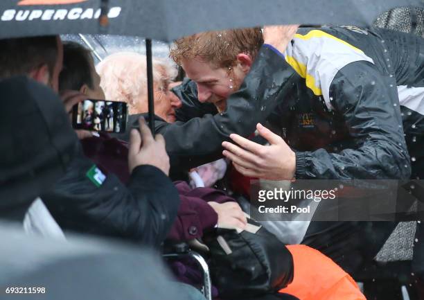 Prince Harry hugs 97-year-old Daphne Dunne, who he had met on an earlier visit to Sydney, during an event where he met members of the public in the...