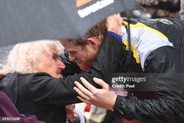 Prince Harry hugs 97-year-old Daphne Dunne, who he had met on an earlier visit to Sydney, during an event where he met members of the public in the...