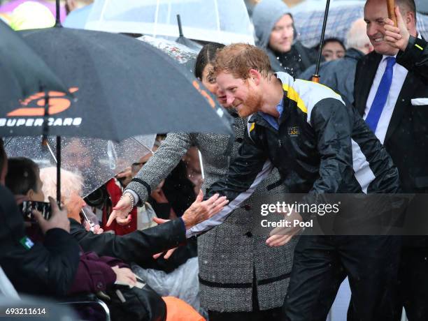 Prince Harry reacts as he recognises 97-year-old Daphne Dunne, who he had met on an earlier visit to Sydney, during an event where he met members of...