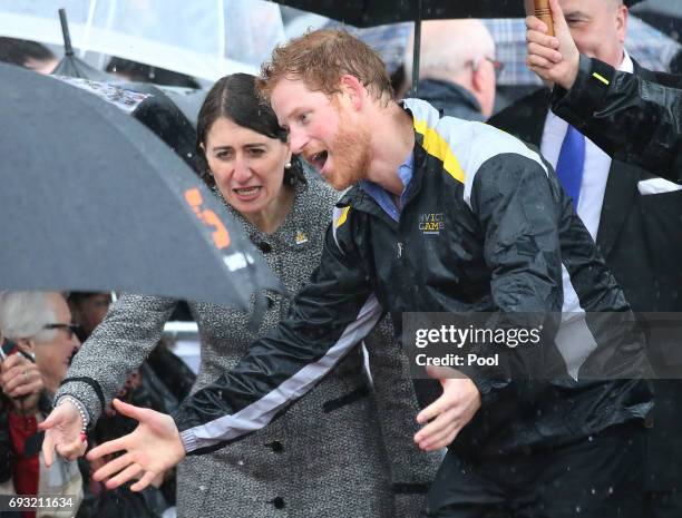 Prince Harry reacts as he recognises 97-year-old Daphne Dunne, who he had met on an earlier visit to Sydney, during an event where he met members of...