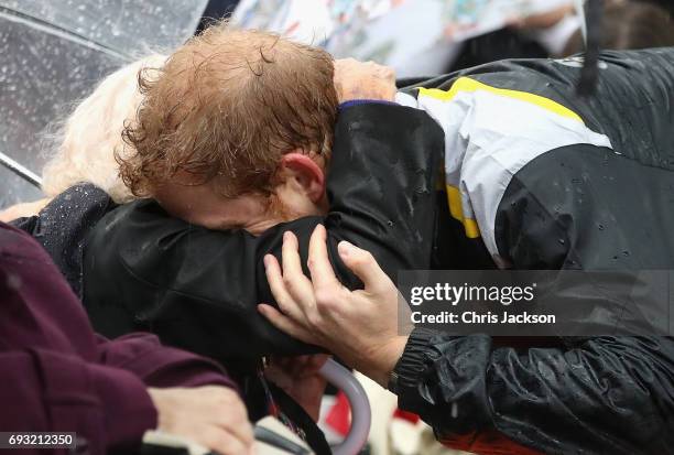 Patron of the Invictus Games Foundation Prince Harry hugs 97 year old Daphne Dunne during a walkabout in the torrential rain ahead of a Sydney 2018...