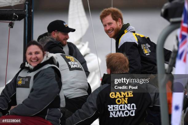 Prince Harry chats with sailors during a sailing demonstration on Sydney Harbour on June 7, 2017 in Sydney, Australia. Prince Harry is on a two-day...