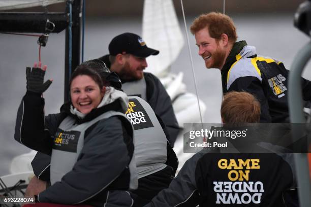 Prince Harry chats with sailors during a sailing demonstration on Sydney Harbour on June 7, 2017 in Sydney, Australia. Prince Harry is on a two-day...