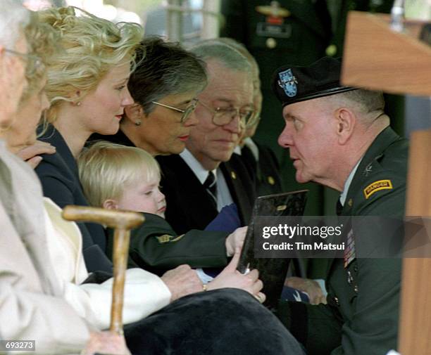Four Star General John Keane, the Vice Chief of Staff for the Army, presents a plaque to Renae Chapman at the internment ceremony for her husband,...