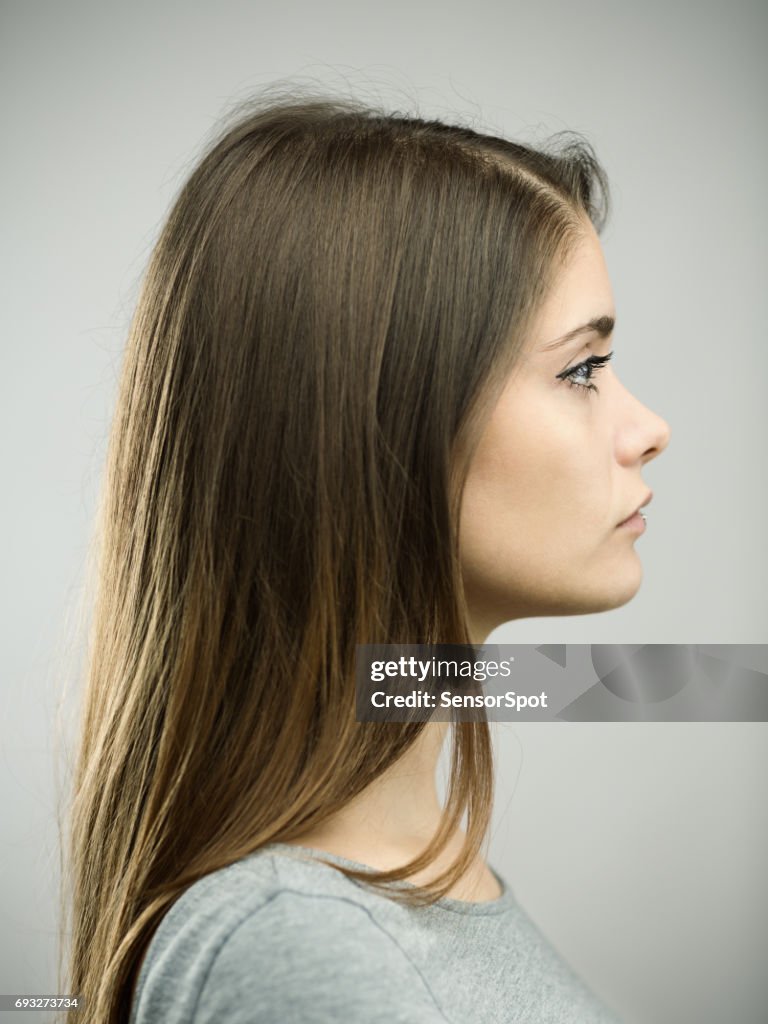 Real young woman profile studio portrait