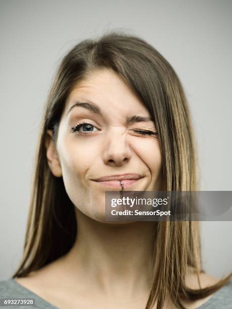 riktigt ung kvinna winking - face close up bildbanksfoton och bilder