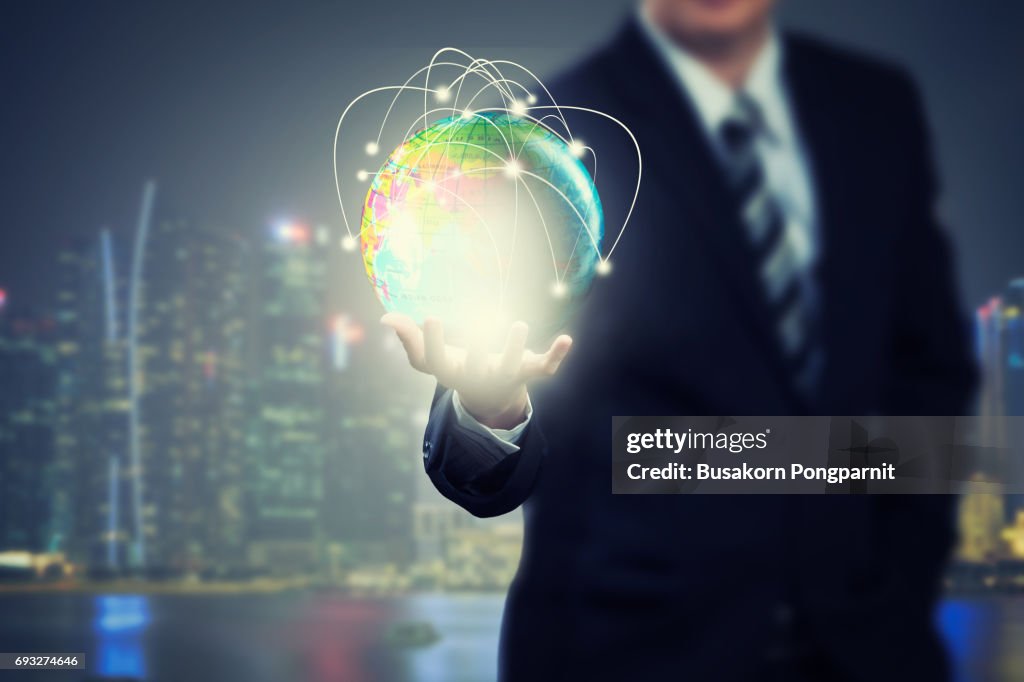 Businessman holding globe network with technology application icons of social network design