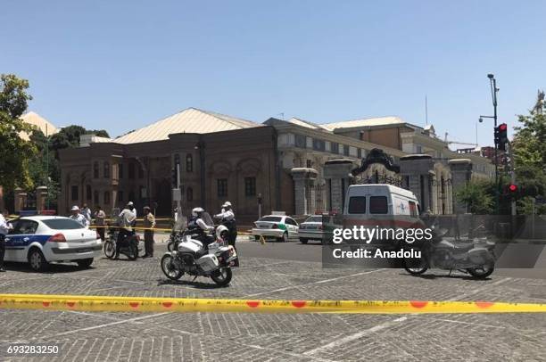 Police take security measures at the scene after gunmen opened fire at Irans parliament and the shrine of Ayatollah Khomeini in the capital Tehran,...
