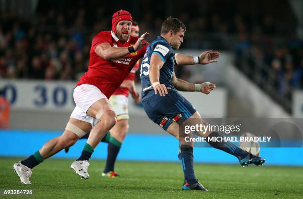 British and Irish Lions' James Haskell attempts to charge down the kick of Auckland Blues' Michael Collins during their rugby union match at Eden...