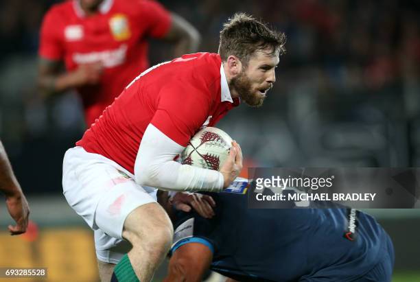 British and Irish Lions' Jack McGrath is tackled during their rugby union match against the Auckland Blues at Eden Park in Auckland on June 7, 2017....
