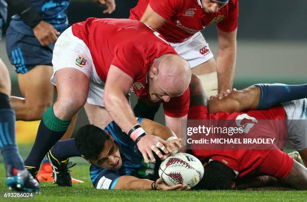 British and Irish Lions' Dan Cole looks to secure the ball from Auckland Blues' Stephen Perofeta during their rugby union match at Eden Park in...