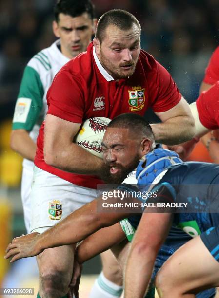 British and Irish Lions' Ken Owens is tackled by Auckland Blues' Charlie Faumuina during their rugby union match at Eden Park in Auckland on June 7,...