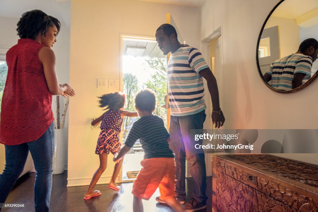 Candid shot of African American family in hallway