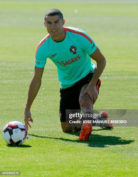 Portugal's forward Cristiano Ronaldo warms up during a training session at "Cidade do Futebol" training camp in Oeiras, outskirts of Lisbon, on June...