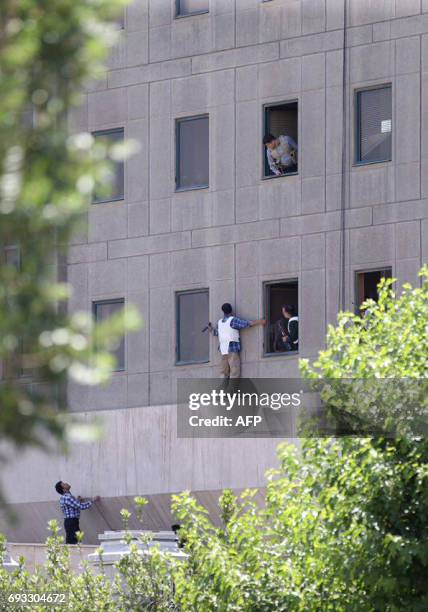 Members of the Iranian security forces are seen outside the Iranian parliament in the capital Tehran on June 7, 2017 during an attack on the complex....