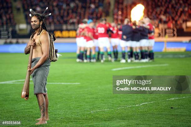 British and Irish Lions have a team huddle behind a "Maori Warrior" during the rugby union match between The British and Irish Lions and Auckland...