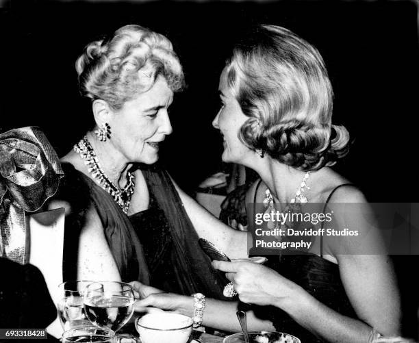 American heiress and businesswoman Marjorie Merriweather Post and her daughter, Dina Merrill , talk together during an unspecified event, Florida,...