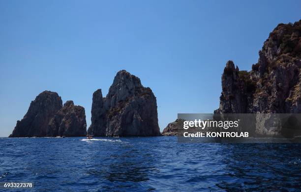 View of the Capri Island, from sea, Faraglioni rock formation, in the bay of Naples, Mediterranean Sea, Campania Region, Southern Italy.