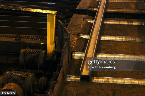 Steel beam moves along a rolling conveyor inside the ArcelorMittal HighVeld Steel & Vanadium Corp. Plant in eMalahleni, South Africa, on Tuesday,...