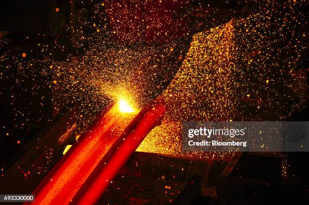 Furnace strikes sparks on a red hot steel beam inside the ArcelorMittal HighVeld Steel & Vanadium Corp. Plant in eMalahleni, South Africa, on...