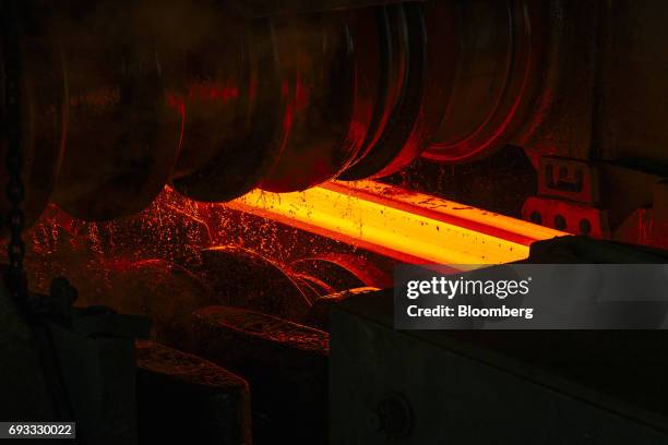 Red hot steel beam is shaped by a rolling machine inside the ArcelorMittal HighVeld Steel & Vanadium Corp. Plant in eMalahleni, South Africa, on...