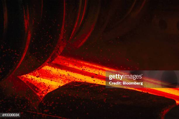 Red hot steel beam is shaped by a rolling machine inside the ArcelorMittal HighVeld Steel & Vanadium Corp. Plant in eMalahleni, South Africa, on...