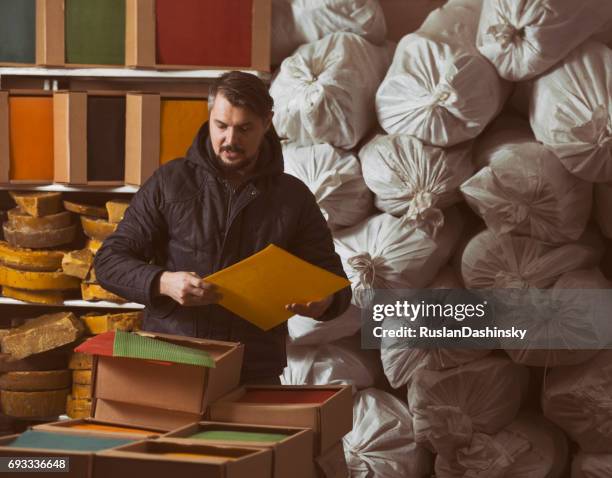 sorting beeswax candle sheets by color. - triage system stock pictures, royalty-free photos & images